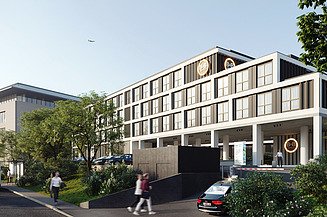 Renderbeeld van het nieuwe B&B Hotel in Diegem. Op het beeld zien we de gevel van het nieuwe hotel met een groene omgevingsaanleg en mensen in het straatbeeld.